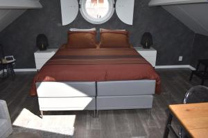 a bedroom with a large bed and a window at van Harte in Zeeland in Kamperland