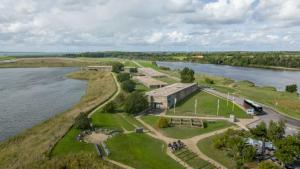 an aerial view of a building next to a river at van Harte in Zeeland in Kamperland