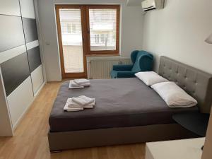 a bedroom with a bed with two towels on it at BT Lux apartment 2 in Skopje