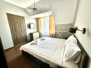 a bedroom with a white bed and a door at Апартамент Свети Влас in Sveti Vlas +14 photos