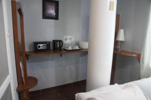 a room with a bed and some shelves on the wall at Green Monkey Resort Boracay in Boracay