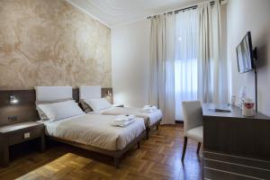 A bed or beds in a room at Guesthouse Vittoria Rooms