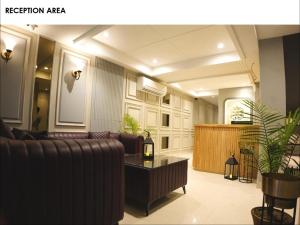 a living room with a couch and a table at Narison by Divud Ecom in Amritsar