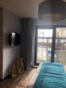 Ένα ή περισσότερα κρεβάτια σε δωμάτιο στο Apartament Willa Port z widokiem na jezioro Premium