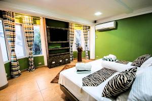 a living room with a white couch and a green wall at Green Monkey Resort Boracay in Boracay