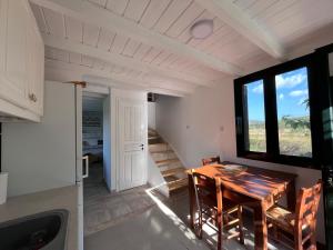 a kitchen and dining room with a wooden table at Gozzadini Vineyard! in Avlonárion