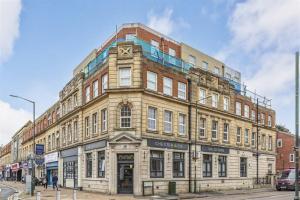 a large building on the corner of a street at Luxurious Apartment in Bournemouth