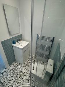 a bathroom with a shower and a sink and a mirror at Luxurious Apartment in Bournemouth +4 photos