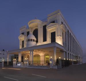 a large white building with a dome on top at Royal Orchid Central, Shimoga in Shimoga