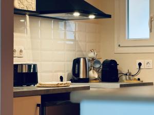 a kitchen with a counter top with a coffee maker at Afrodite's Loft & Studios in Paleokastritsa
