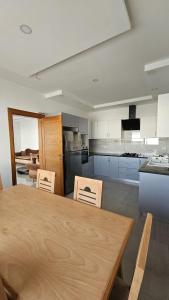 a large kitchen with a wooden table and chairs at Villa Zain in Houmt Souk