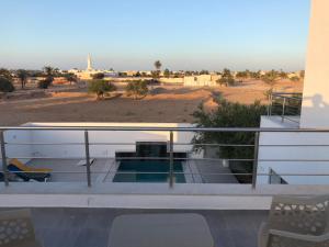 a balcony of a house with a view of the desert at Villa Zain in Houmt Souk