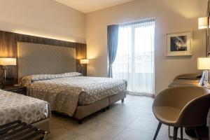 Postel nebo postele na pokoji v ubytování Hotel Kuma
