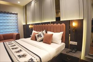 a bedroom with a large bed with pillows on it at Narison by Divud Ecom in Amritsar +54 photos