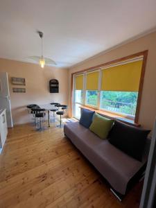 a living room with a couch and a table at Willa Zuza in Kołobrzeg