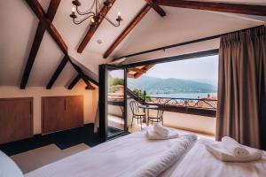 a bedroom with a bed and a balcony at Villa Pupin Gorna Porta in Ohrid