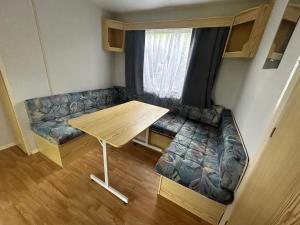 a living room with a couch and a table at Cabanon dans le jardin in Gaillac