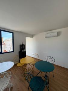 a room with two tables and chairs and a window at Borgomara Bed and Breakfast in Marina di Schiavonea