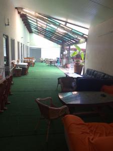 a room with tables and chairs and a room with tables at Casa inflorita camere in Eforie Nord