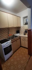 a kitchen with white cabinets and a stove at Apartment Eden in Crikvenica +22 photos