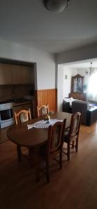 a dining room table and chairs in a living room at Apartment Eden in Crikvenica