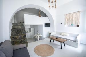 a living room with a couch and a table at Ostria kythnos apartment in Kithnos