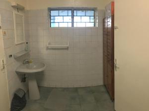 a bathroom with a sink and a window at Farida Lodge in Moroni