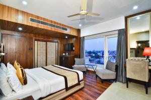 a hotel room with a bed and a balcony at Sawera Grand Luxury Stay Near Golden Temple in Amritsar