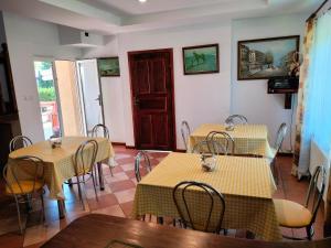 restauracja z dwoma stołami i krzesłami oraz drzwiami w obiekcie Prezydencja w mieście Białogóra
