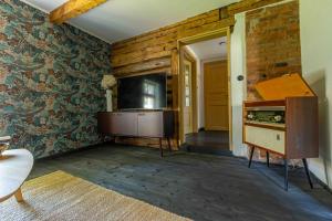 a living room with a tv and a brick wall at Mönus Pesa in Kuressaare