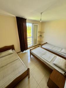 two beds in a room with a window at Lali in Ureki