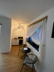 a room with a table and chairs and a window at Casa de Caramida in Braşov