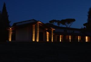 a building with lights on it at night at Fattoria Lucciano in Borghetto