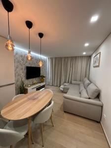 a living room with a table and a couch at Appartement T2 vue sur mer, Place Méditerranée in Canet-en-Roussillon