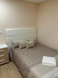 a bedroom with a bed and a dresser in it at Appartement T2 vue sur mer, Place Méditerranée in Canet-en-Roussillon