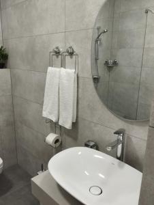 a bathroom with a white sink and a mirror at Hotel IUG in Taraclia