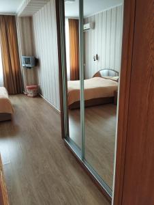 a mirror in a room with a bed and a bedroom at Hotel IUG in Taraclia