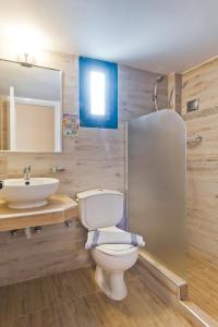 a bathroom with a toilet and a sink at Kyra Panagia Hotel in Kyra Panagia