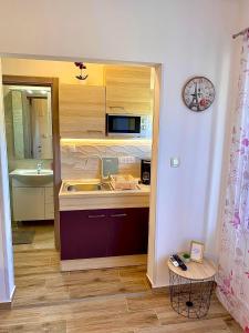 a small kitchen with a sink and a microwave at Apartman Miljenko - Matovica in Kampor +38 photos