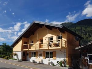 a building with a balcony on the side of it at Haus Idili in Sankt Gallenkirch
