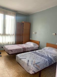 Ein Bett oder Betten in einem Zimmer der Unterkunft Hostal Rural Can Enric