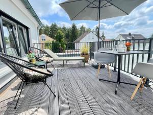a patio with a table and chairs and an umbrella at Apartment Living in Schwabach