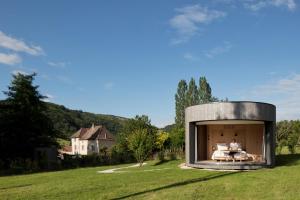 a round house in a grassy field with a person in a bed at Tomette Singulière in Château +108 photos