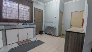 a kitchen with a sink and a counter top at Bunut Centre Stay in Bandar Seri Begawan