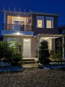 a house with a front door at night at Oikies in Prinos