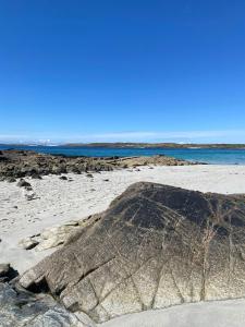a large rock sitting on a beach next to the ocean at Doonhill Lodge in Galway