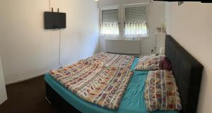 a bedroom with a bed with a quilt on it at Gemütlicher Bungalow in Barum