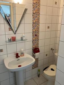 a bathroom with a sink and a toilet at Gemütlicher Bungalow in Barum +8 photos