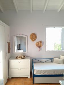a bedroom with a bed and a mirror and a dresser at Vasiliki in Kavála