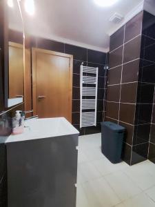 a bathroom with a sink and a toilet and a mirror at Casa da Avo Maria - 2 in Podence